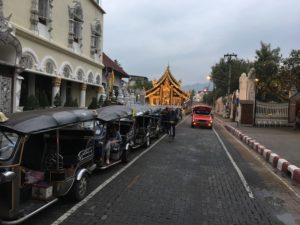 Three-wheeled tuk-tuks/rickshaws and red taxi pickups are popular public transportation methods